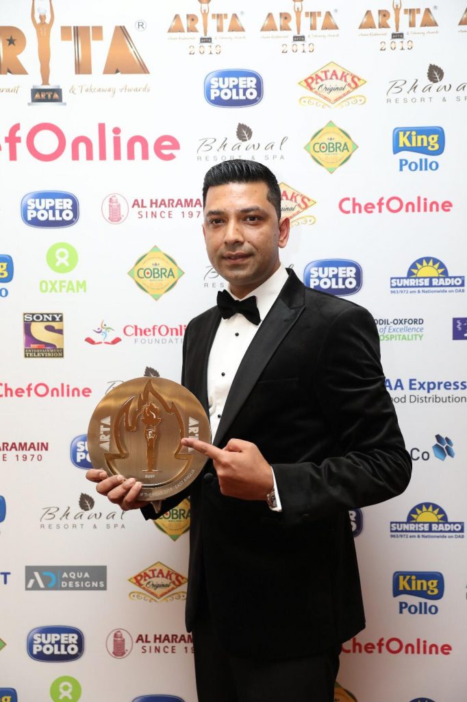 Ruby founder Naz receiving a restaurant award